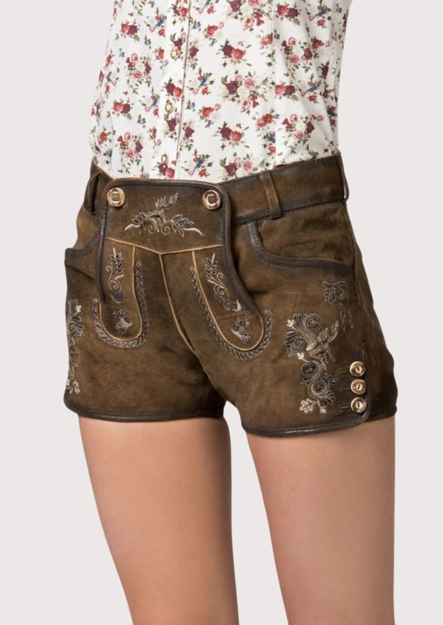 Classic women’s lederhosen in premium leather with floral embroidery, perfect for Oktoberfest and traditional events.