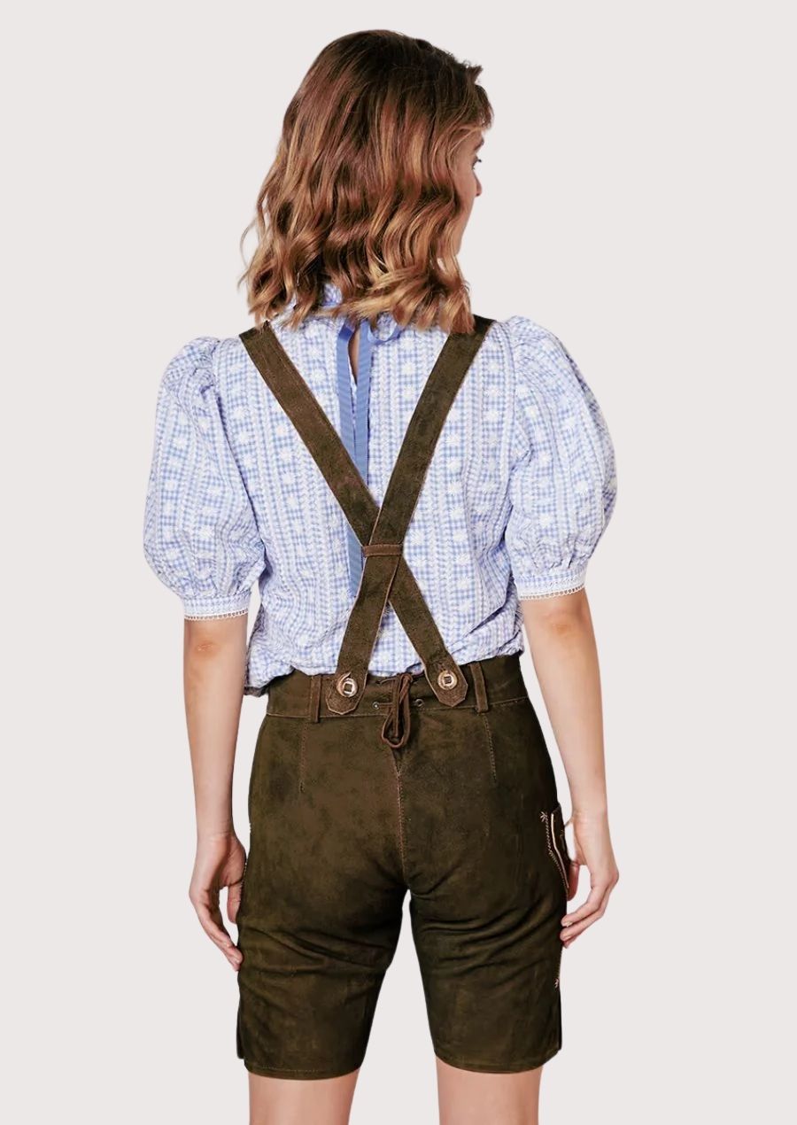 Authentic alpine female lederhosen shorts paired with traditional patterned German blouse