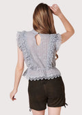 Authentic alpine women’s lederhosen outfit with decorative embroidery and fitted lace top
