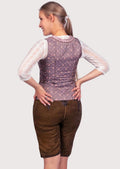 Authentic Alpine women's festival outfit featuring embroidered leather lederhosen, decorative bodice, and traditional styling.