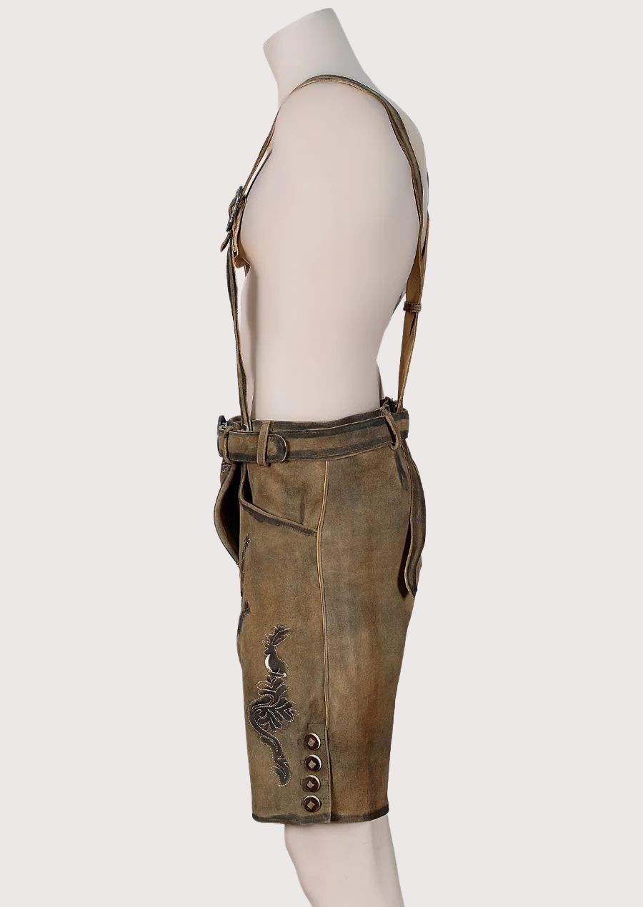 Authentic Bavarian lederhosen outfit featuring embroidered leather braces, brown suede finish, and classic German styling
