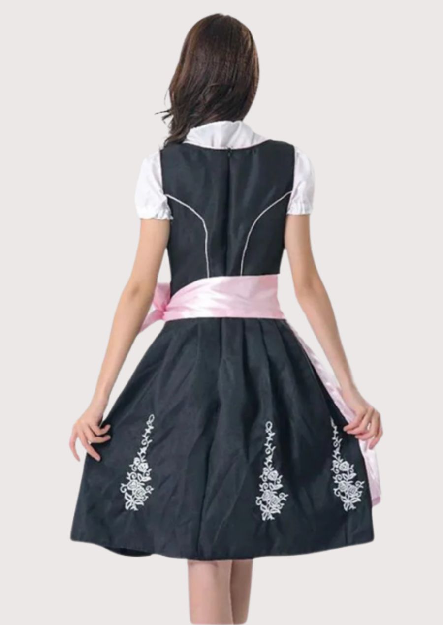 Authentic Alpine Dirndl dress with white floral embroidery, blush pink ribbon apron, fitted bodice, and traditional Bavarian styling.