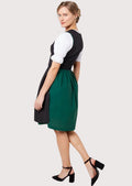 Authentic German Dirndl outfit with a lace-up bodice, white puff sleeves, black ribbon waist tie, and elegant green detailing.