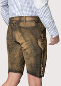 Distressed olive brown lederhosen featuring artisan embroidery, side buttons, and traditional craftsmanship