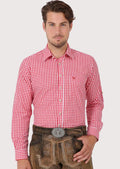 Man wearing red checkered Bavarian Trachten shirt and traditional leather lederhosen

