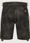 Authentic black suede lederhosen showcasing green floral embroidery and heritage German design