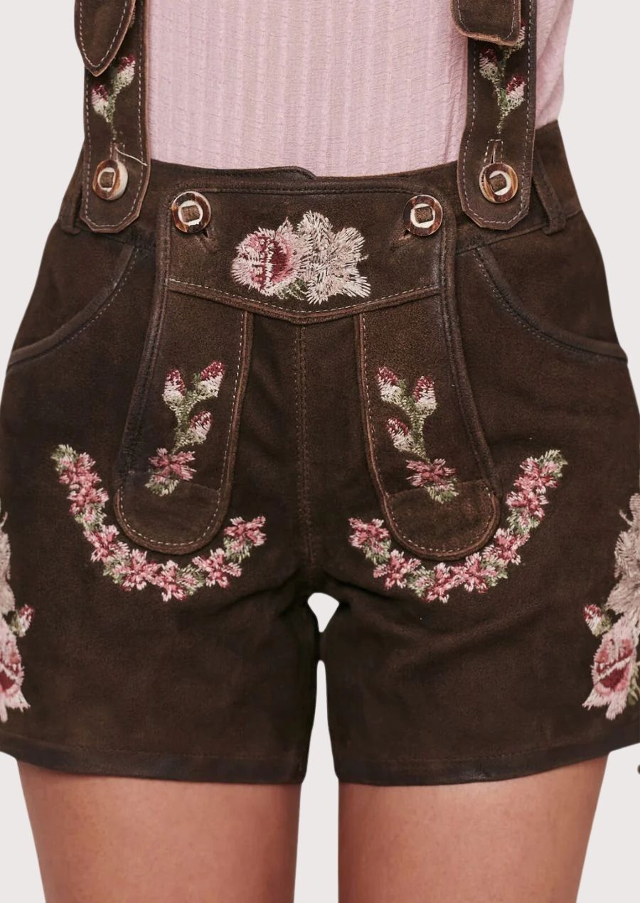Bavarian trachten women’s lederhosen styled with floral embroidery and lace sleeve blouse