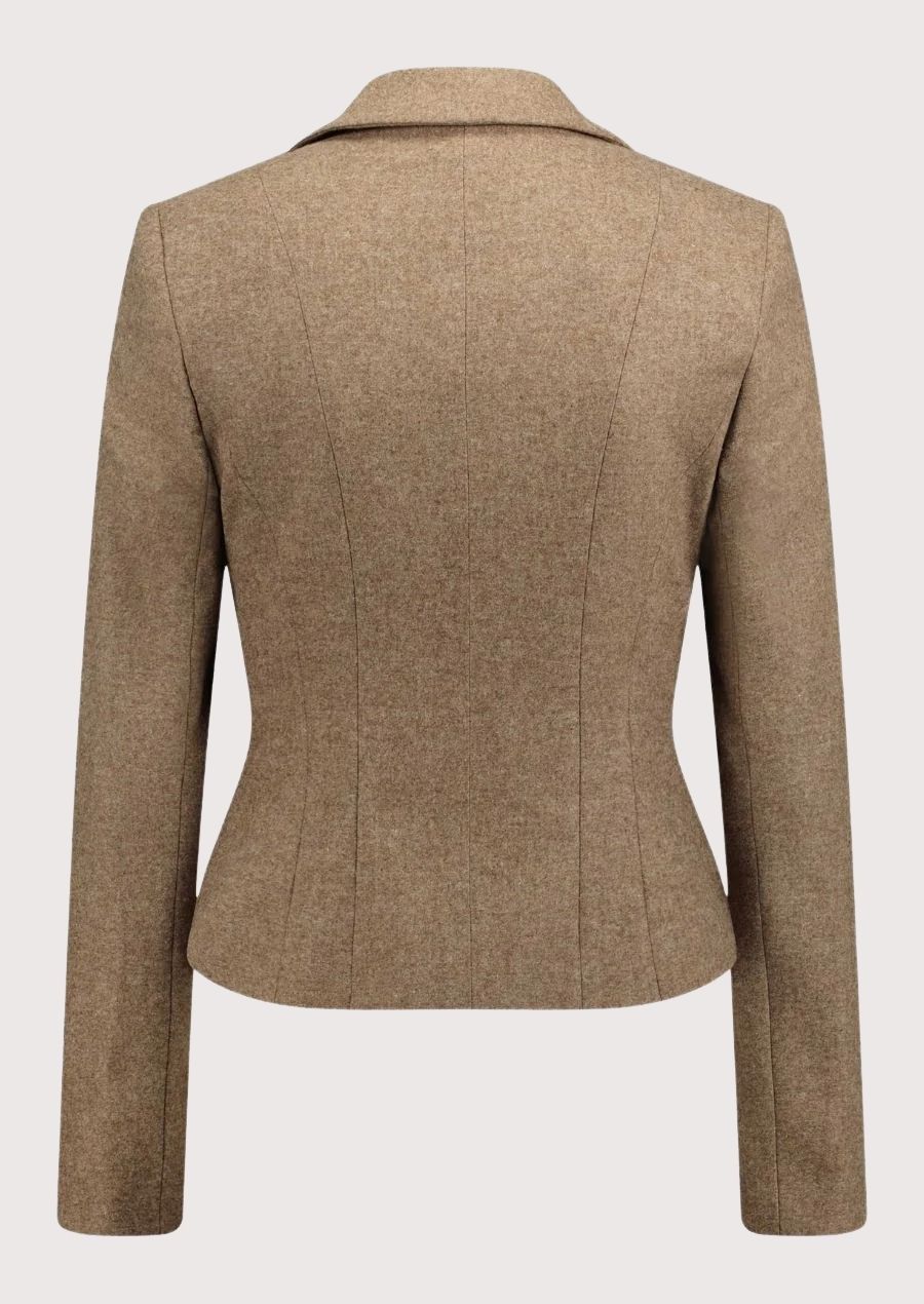 Beige women’s alpine blazer with fitted waist and decorative metal buttons.