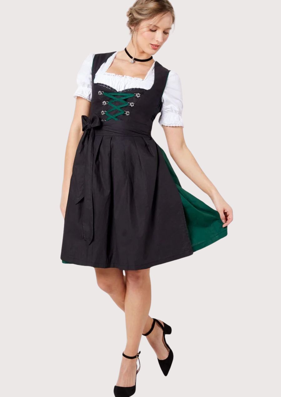 Women's black Dirndl dress with emerald green lace-up bodice, white puff sleeve blouse, black ribbon waist tie, traditional Bavarian Oktoberfest outfit, authentic German Trachten clothing.