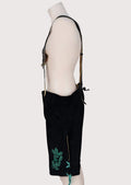Black goatskin suede lederhosen with green embroidery, decorative suspenders, and traditional Bavarian craftsmanship