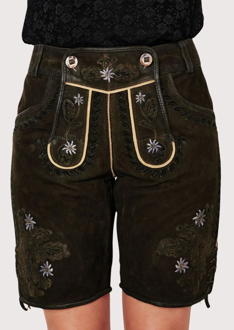Women's heritage black lederhosen shorts with embroidered Edelweiss details, rustic suede texture, and classic Alpine charm.