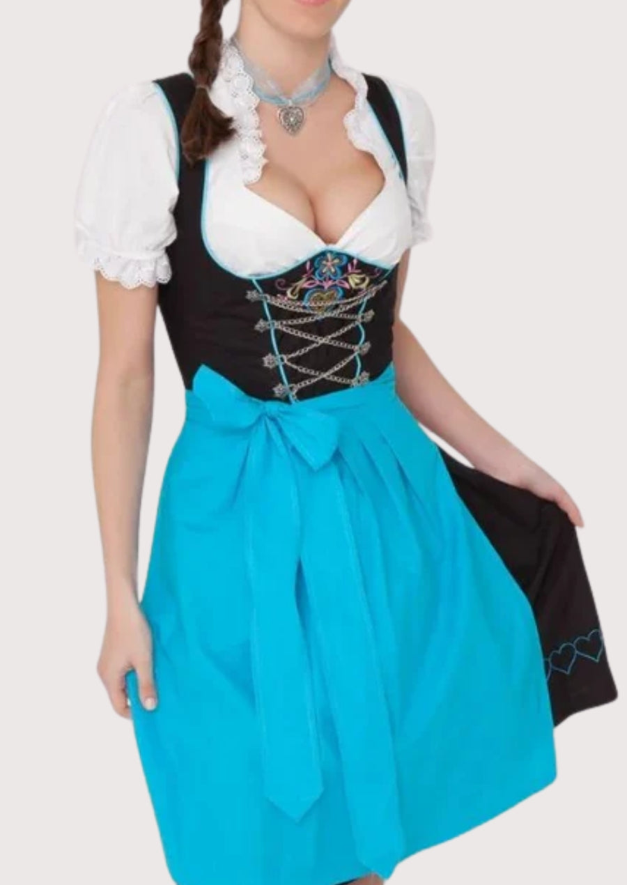 Blue traditional dirndl dress featuring a black embroidered bodice, white blouse, lace-up front, and matching apron in classic Alpine women’s fashion style.