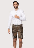 Dark brown goatskin suede lederhosen featuring ivory floral embroidery and authentic Bavarian styling