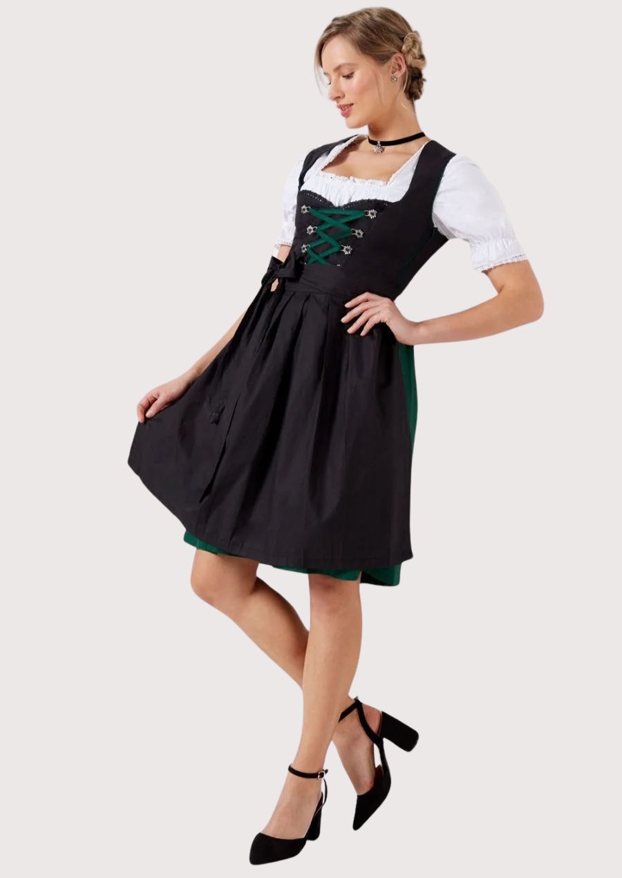 Traditional women's Dirndl dress with modern comfort, featuring a stylish black skirt, green laced bodice, and elegant bow tie detail.