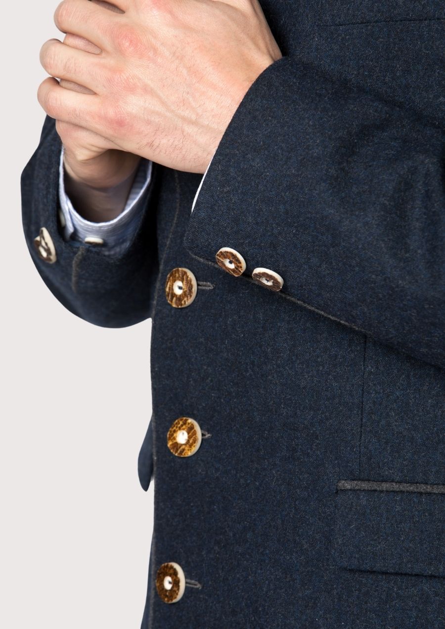 Classic alpine men’s jacket crafted from dark blue wool fabric.