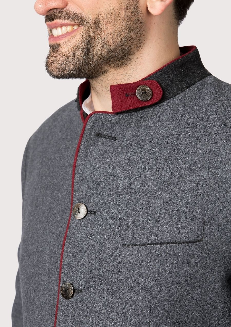 Classic alpine wool jacket in grey with red accent detailing.