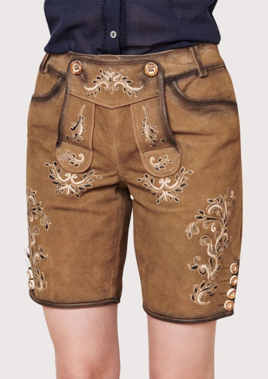 Classic Bavarian women’s outfit featuring traditional leather lederhosen and folk blouse