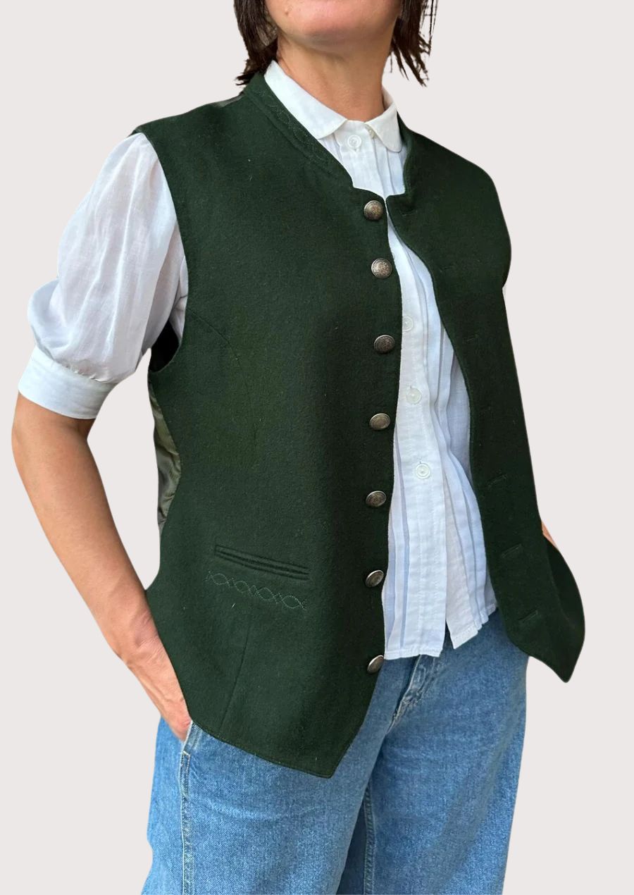 Classic women’s sleeveless green waistcoat with metal buttons.