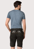 Distressed black suede lederhosen showcasing silver embroidery, side ties and heritage craftsmanship