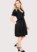 Elegant black Bavarian Dirndl with decorative silver corset hooks, fitted waist, short puff sleeves, and traditional German fashion.