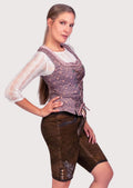 Elegant women's Trachten lederhosen set with embroidered knee-length shorts, lace sleeves, and Alpine-inspired detailing.