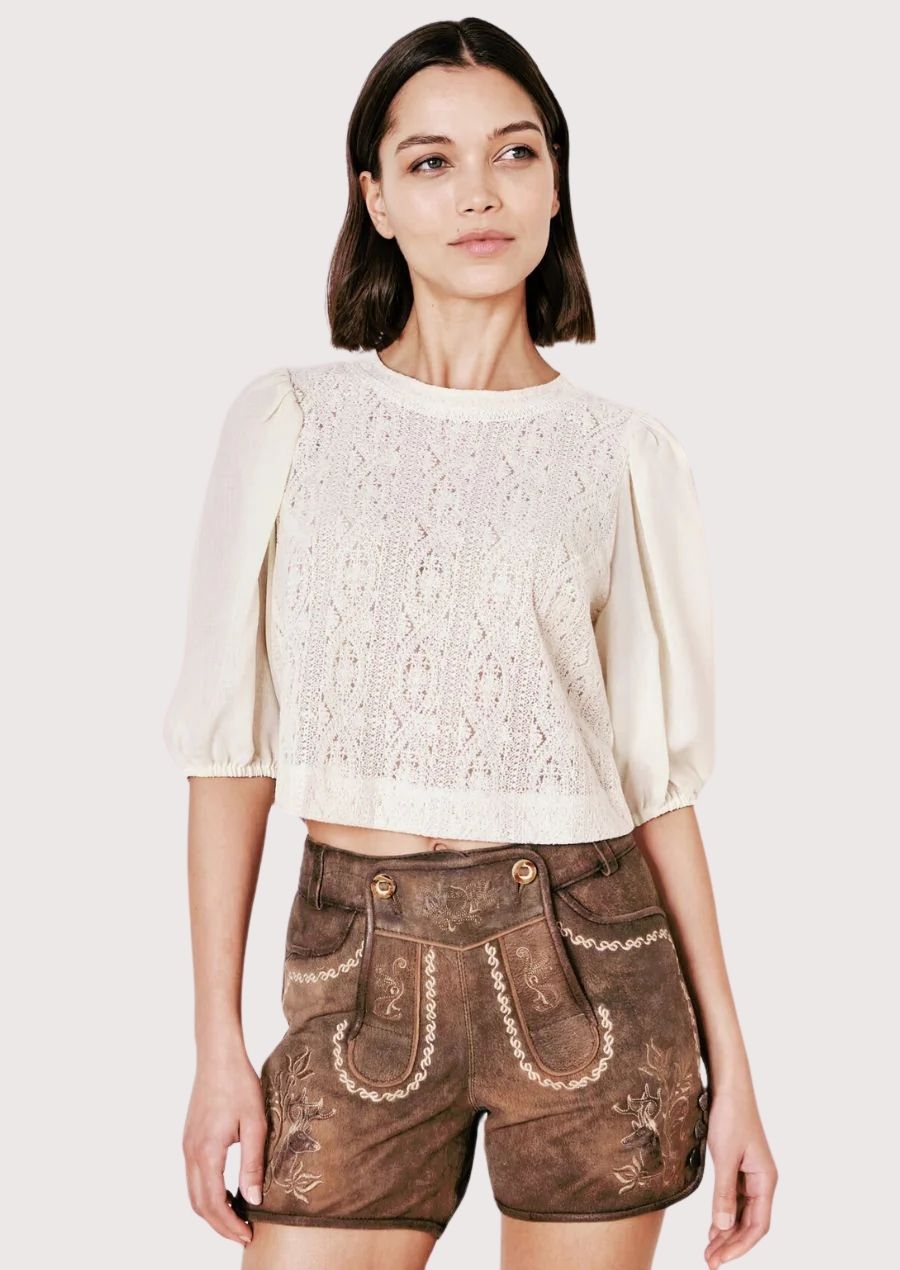 Festive lederhosen for women with intricate floral embroidery, perfect for Oktoberfest and cultural events.