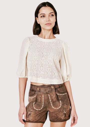 Festive lederhosen for women with intricate floral embroidery, perfect for Oktoberfest and cultural events.