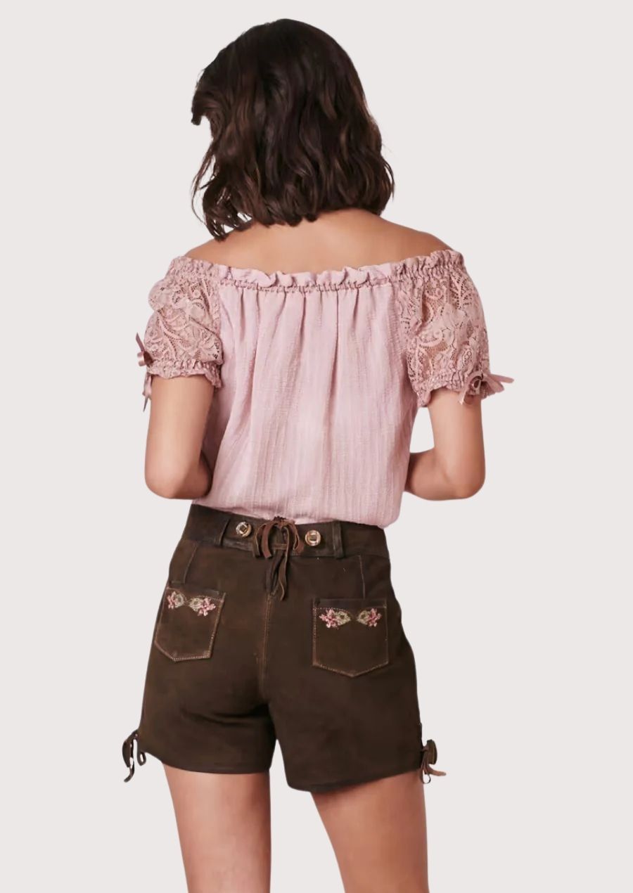 Floral Bavarian lederhosen for women crafted with embroidered rose motifs, heritage details, and classic Trachten appeal.