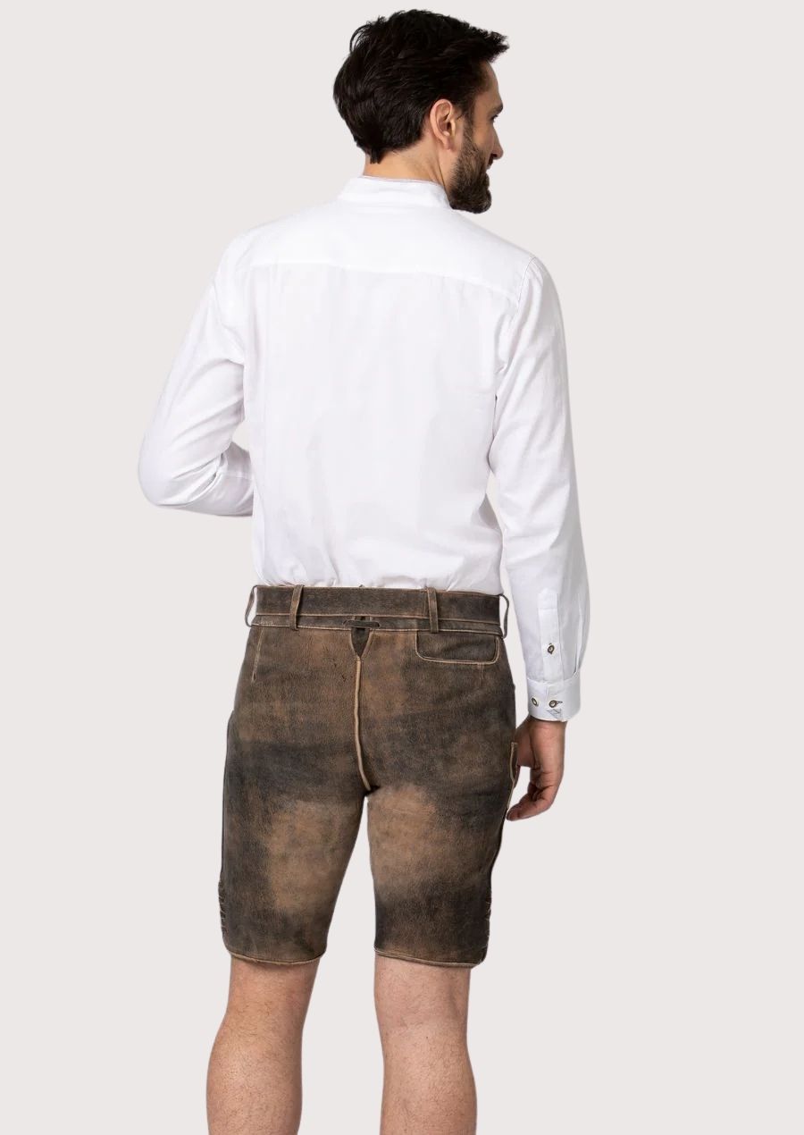 Heritage-style brown lederhosen crafted with decorative floral embroidery and distressed leather texture