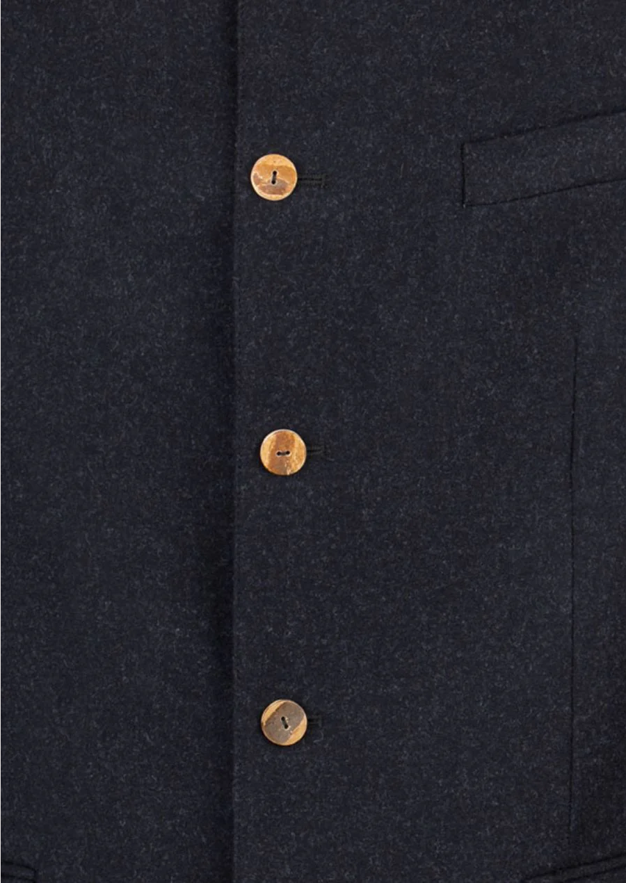 Close-up of buttoned wool Trachten jacket with mandarin collar