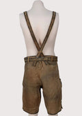 Brown Bavarian lederhosen shorts with matching suspenders, ornate embroidery, and rustic leather finish