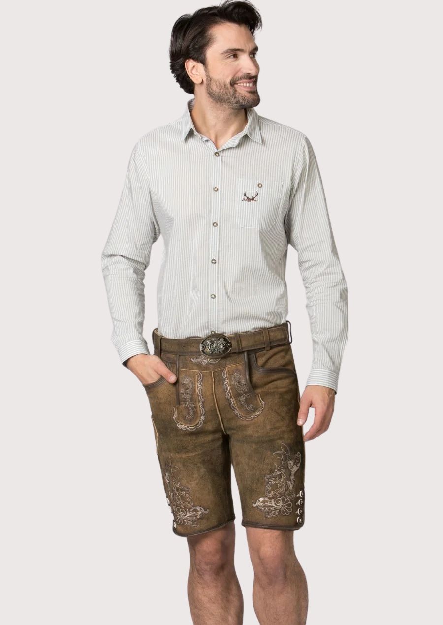 Male model wearing brown embroidered lederhosen shorts with a light striped button-down shirt in traditional Bavarian style