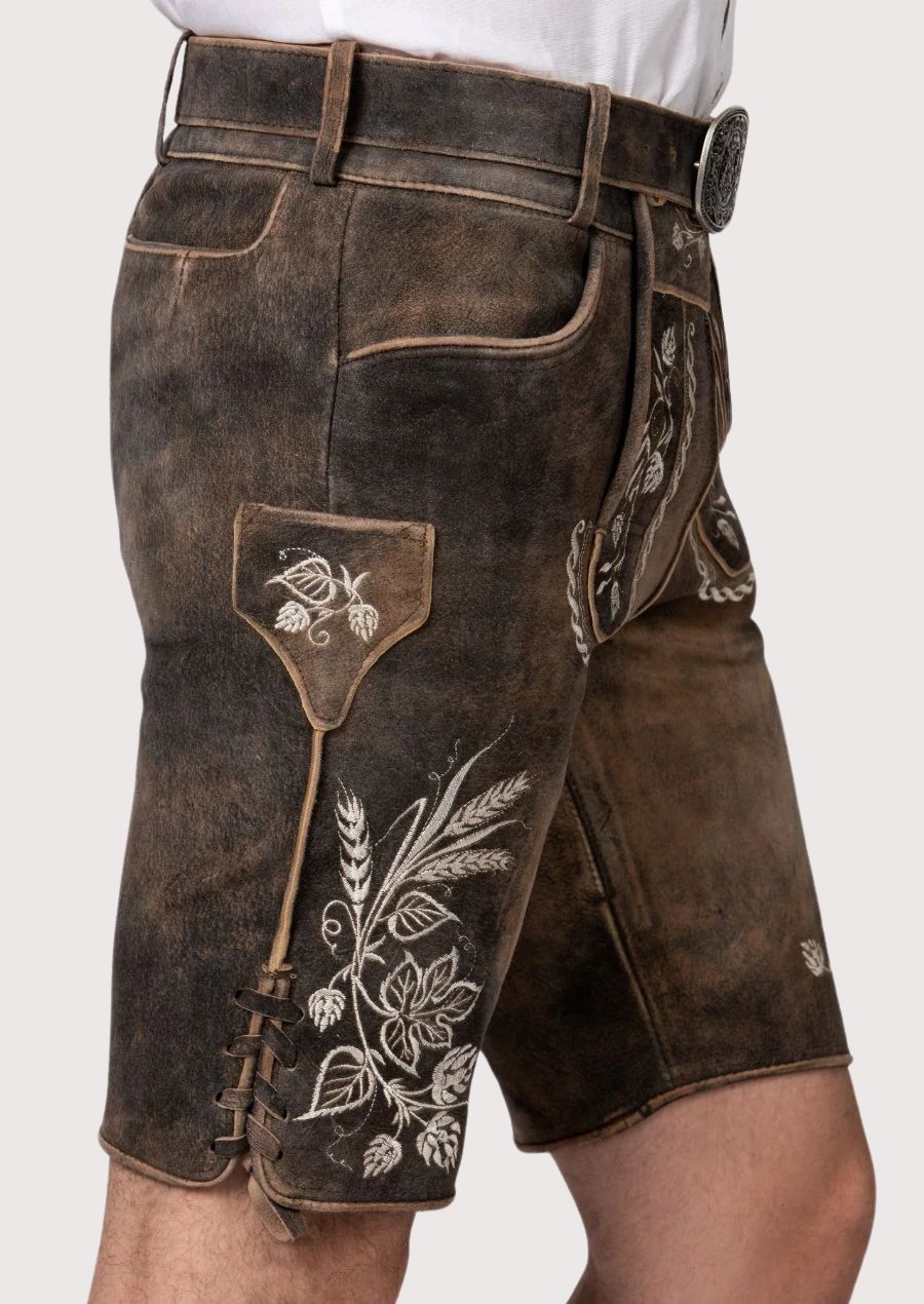 Premium goatskin lederhosen featuring intricate ivory embroidery and vintage Oktoberfest appeal