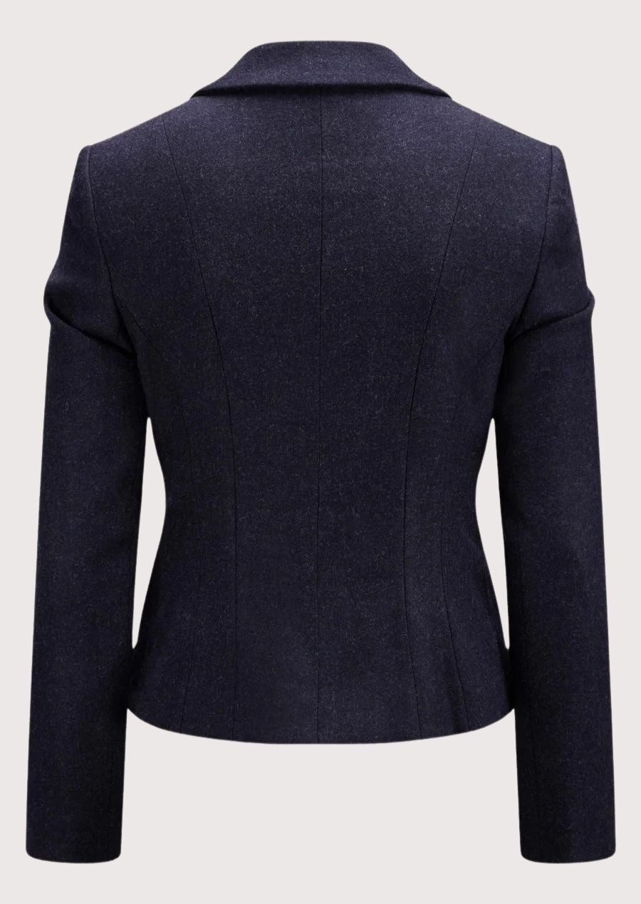 Navy women’s alpine blazer with tailored waist and decorative metal buttons.