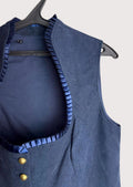 Navy women’s traditional bodice vest with brass buttons.