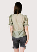 Oktoberfest women’s lederhosen outfit combining grey leather shorts and traditional blouse