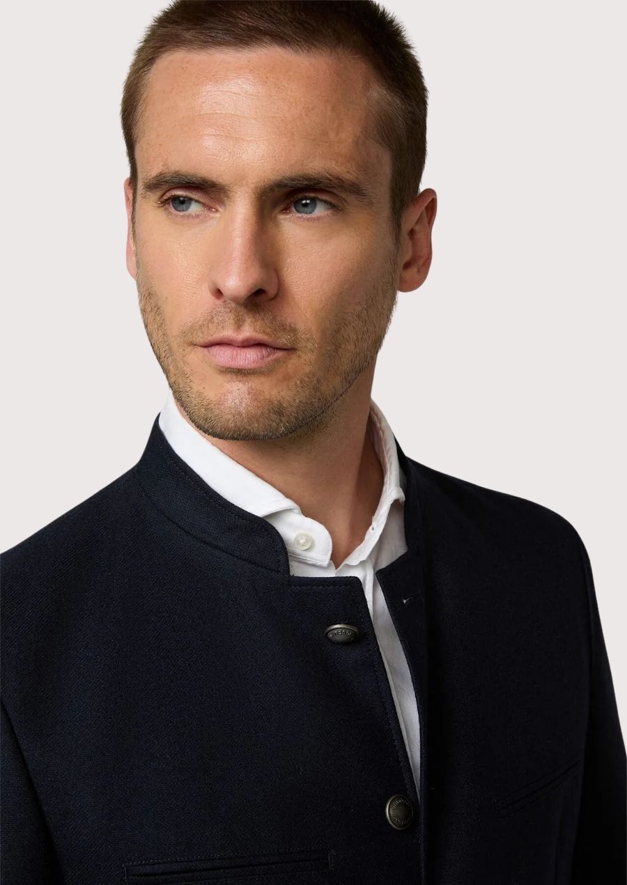 Premium alpine jacket in blue with metal buttons.