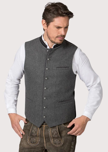 Man wearing a classic Bavarian wool vest in alpine gray

