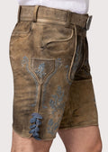 Premium beige lederhosen shorts featuring detailed blue embroidery and authentic Oktoberfest appeal