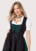 Premium German Dirndl dress crafted with a black apron, emerald green bodice accents, lace-up corset, white blouse, and elegant Bavarian styling.