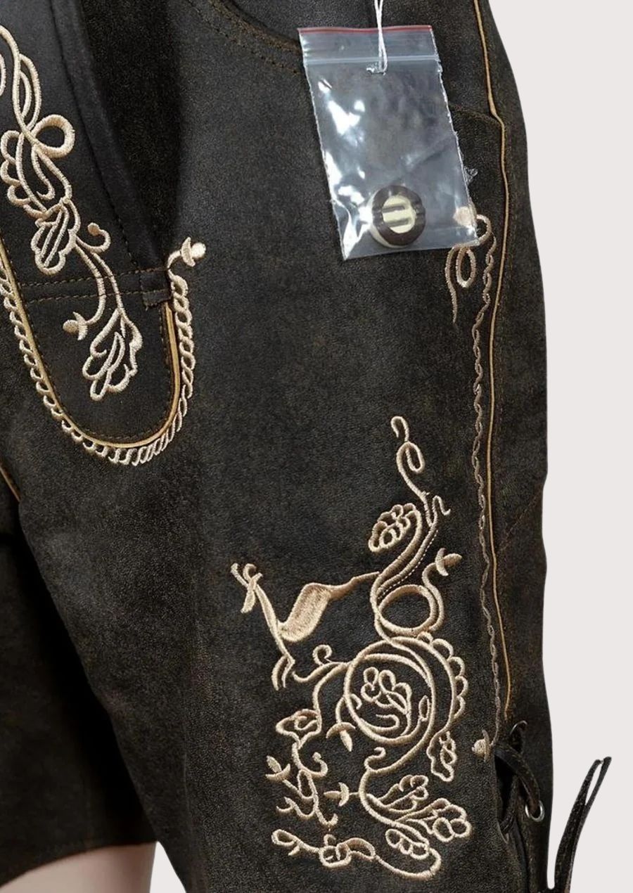 Authentic black leather lederhosen featuring embroidered suspenders and classic Alpine craftsmanship