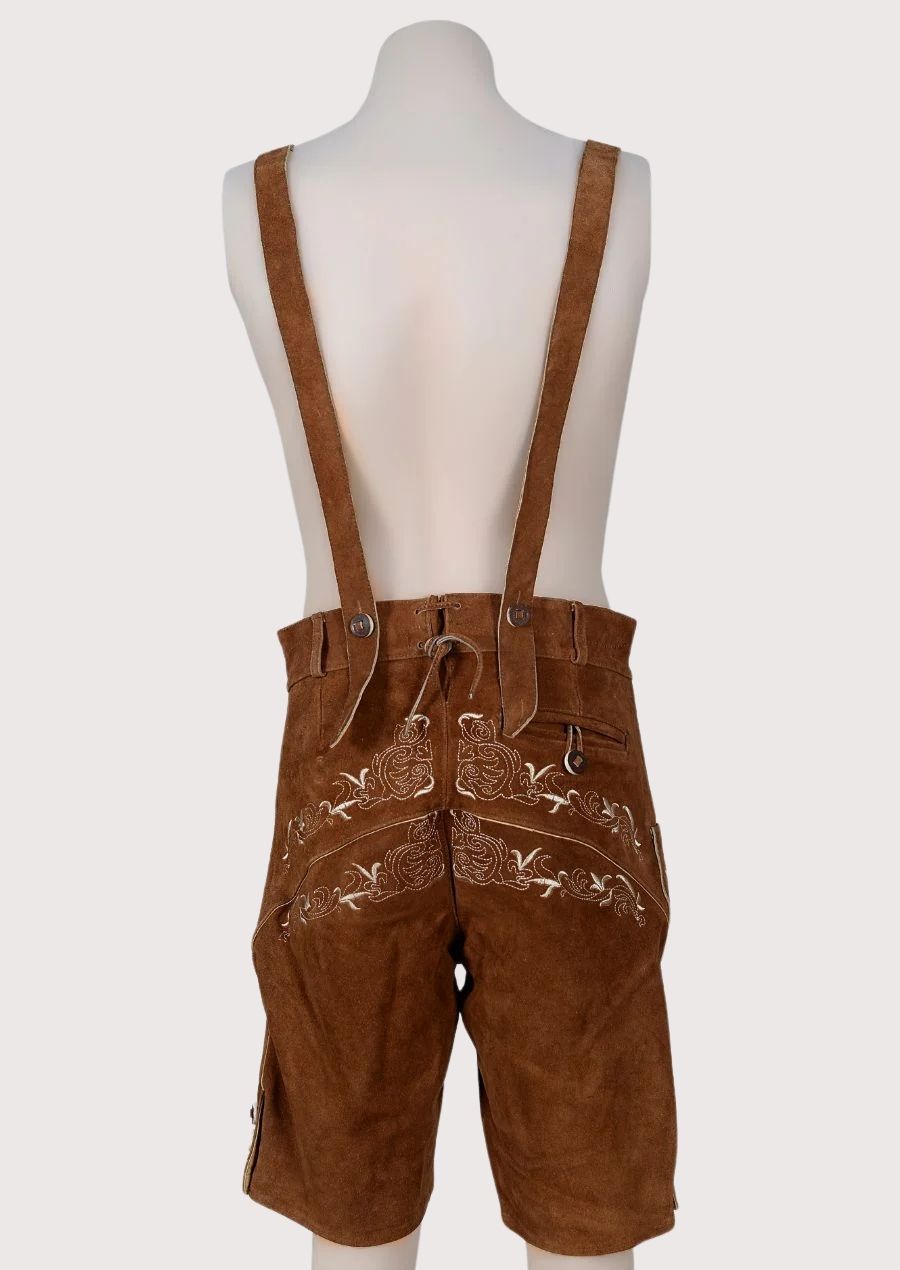 Premium brown suede lederhosen with detailed embroidery, adjustable suspenders, and authentic Oktoberfest styling