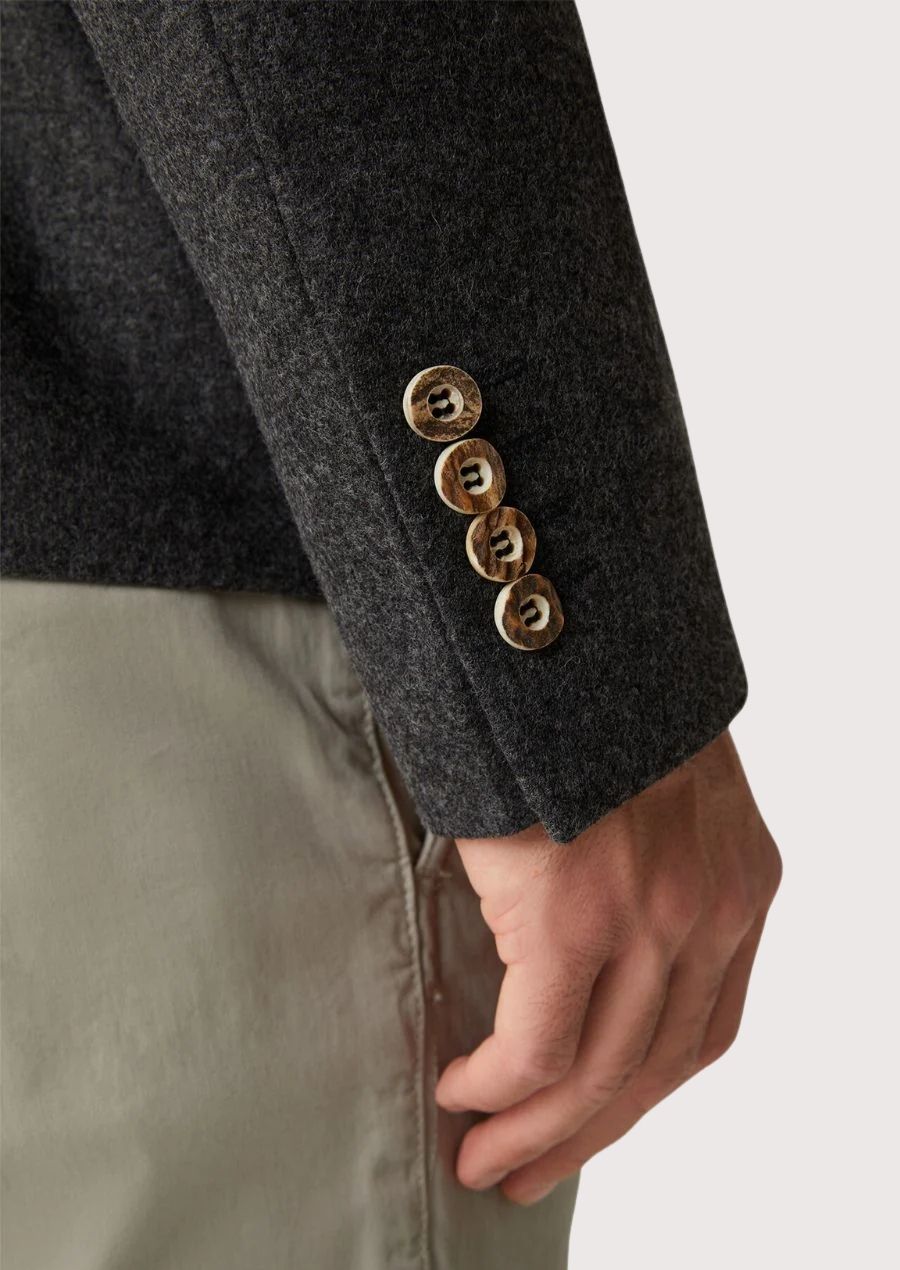 Premium charcoal Oktoberfest jacket made from wool, shown in front and back views with heritage buttons, slim silhouette, and formal alpine cut.