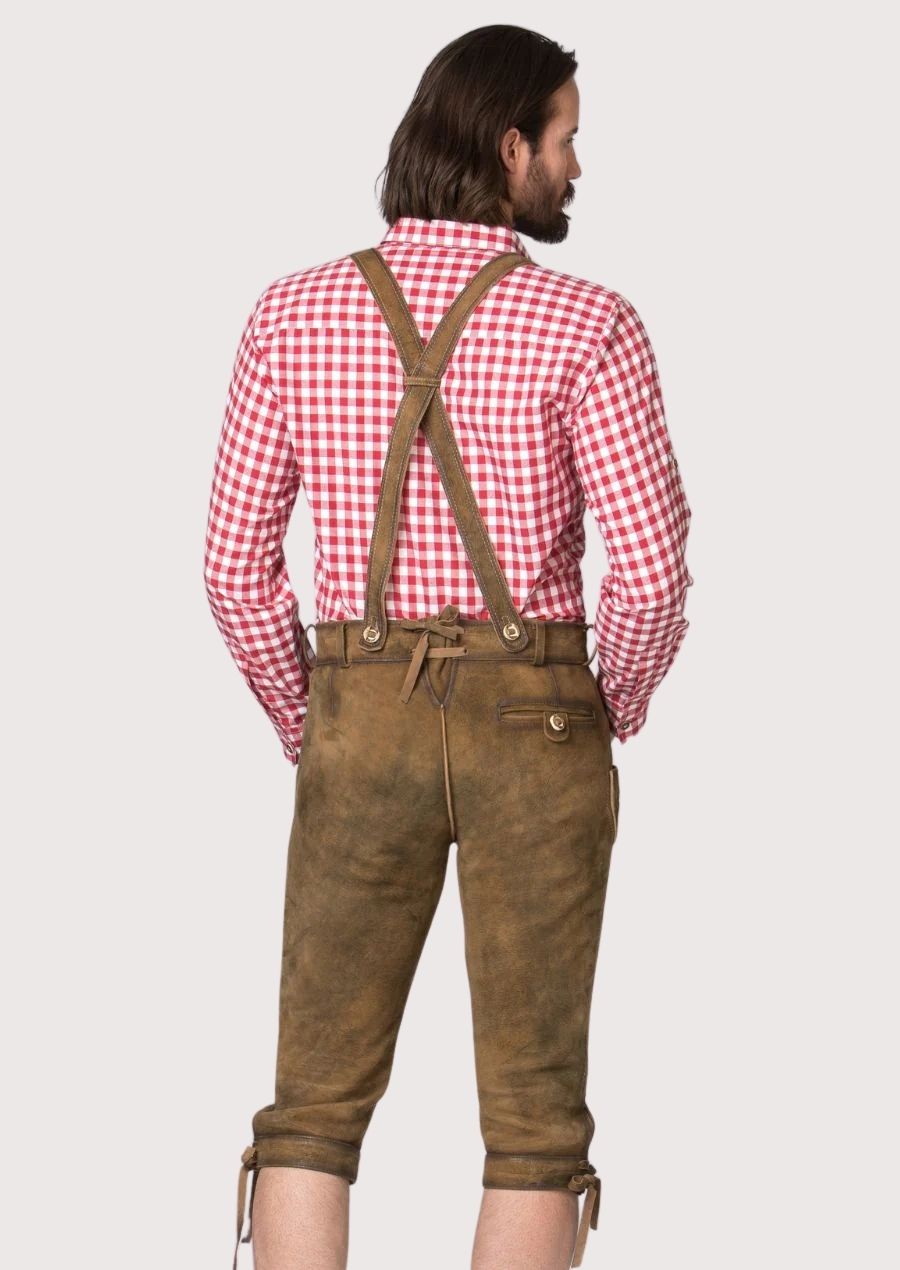 Premium German Bundhosen in distressed goatskin suede paired with traditional suspenders and embroidered accents