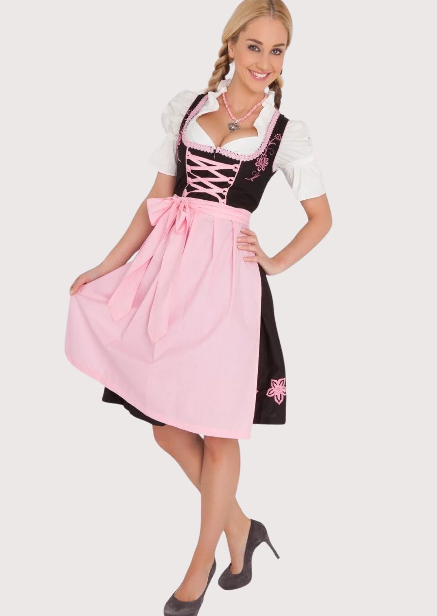 Premium Oktoberfest Dirndl with embroidered floral accents, pink ribbon corset lacing, white puff sleeves, and a flowing pastel pink apron.