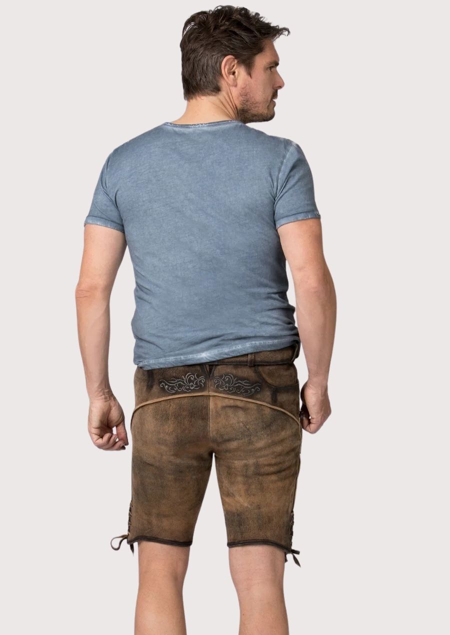 Rustic German lederhosen featuring embossed floral artwork, dark embroidery and side lacing accents