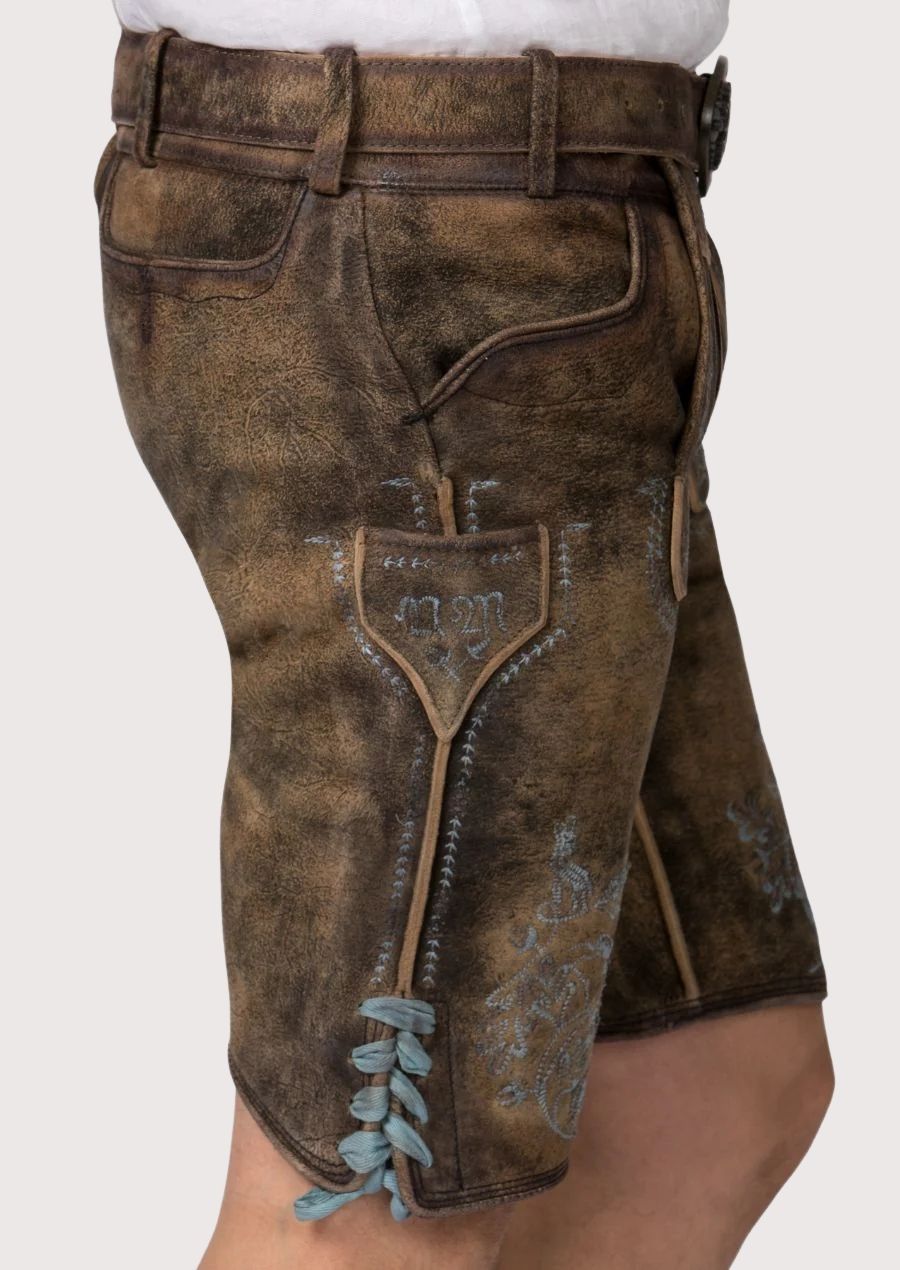 Rustic German lederhosen shorts showcasing heritage-inspired blue embroidery and vintage leather texture