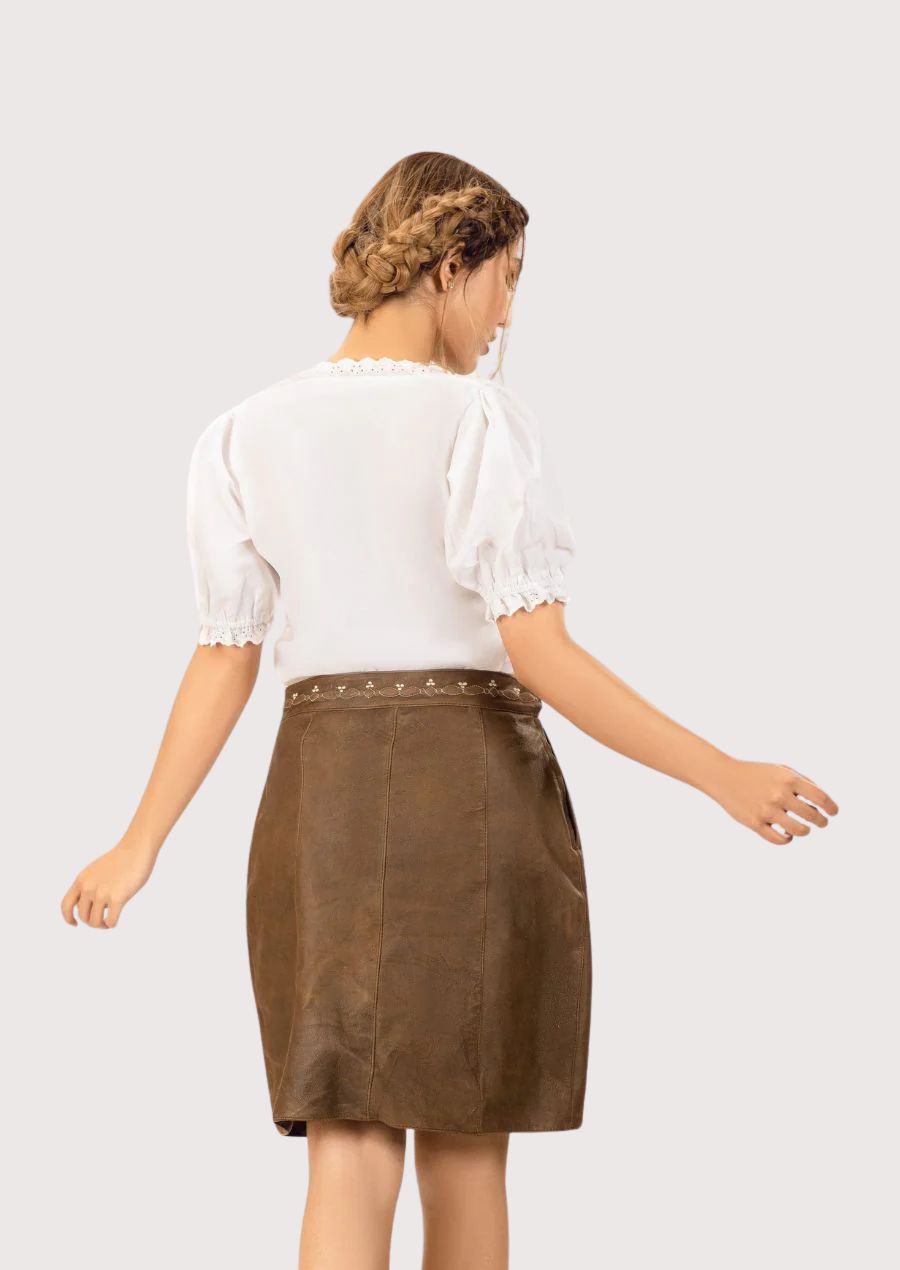 Rustic brown genuine leather skirt with soft suede finish, decorative embroidered waistband, and timeless everyday styling.