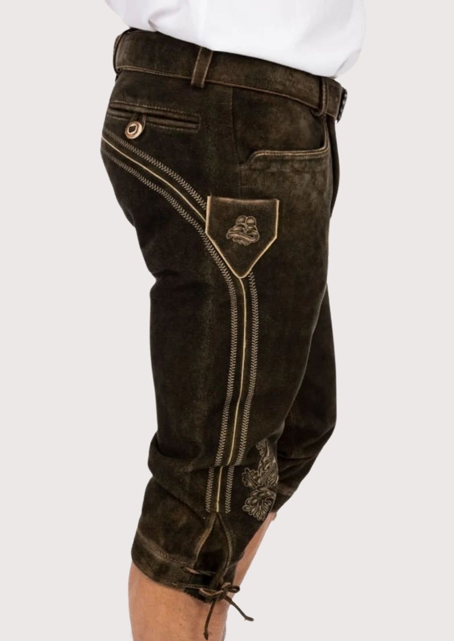 High-quality suede leather Bundhosen for men with metal buckle details and floral embroidery, ideal for Oktoberfest, cultural events, and outdoor festivals.