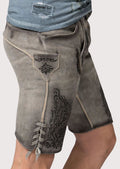 Men’s lederhosen with antique-style buttons and detailed floral stitching for festive occasions.